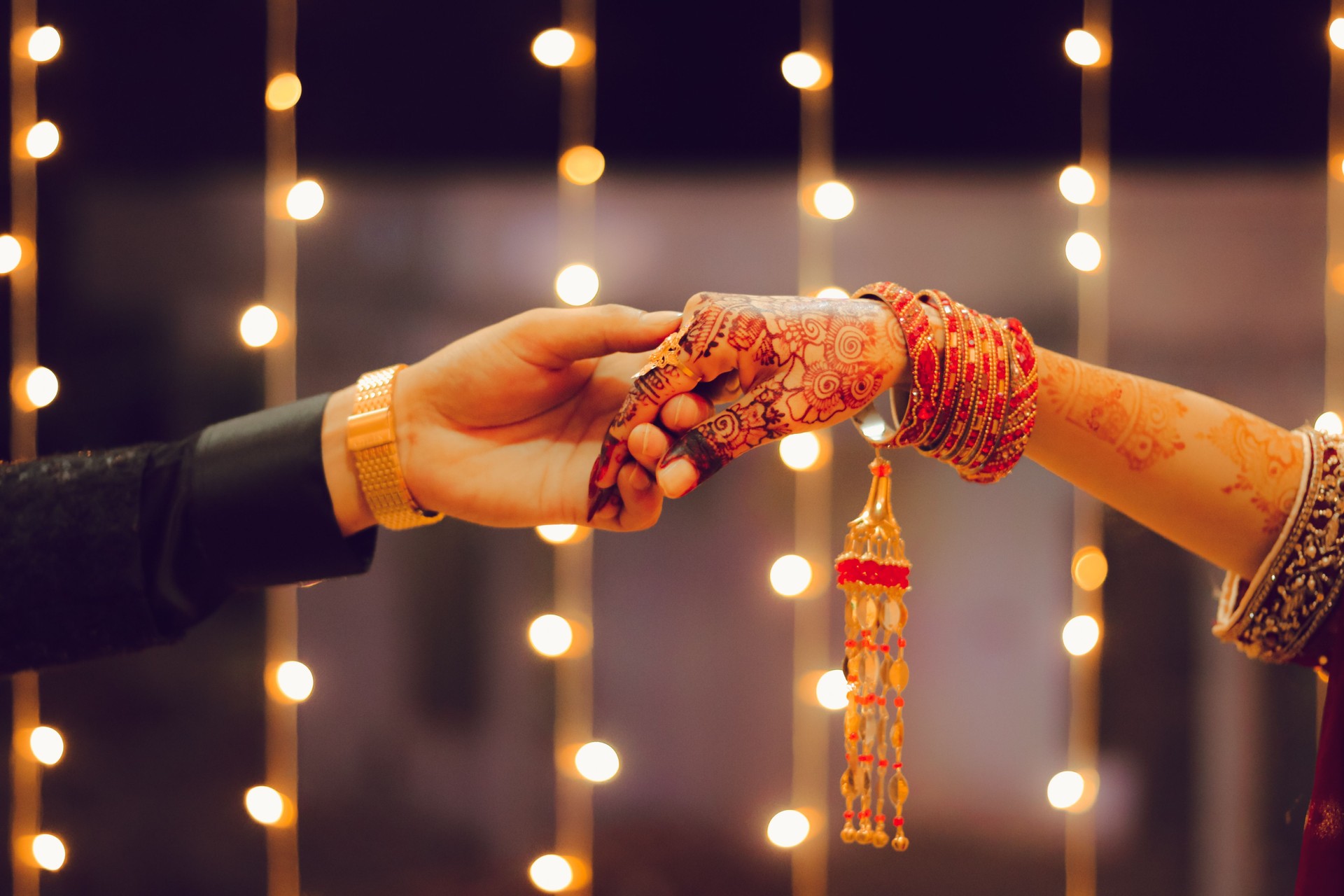 Indian or Pakistani  desi Couple Holding hands wearing vintage jewelry during wedding season