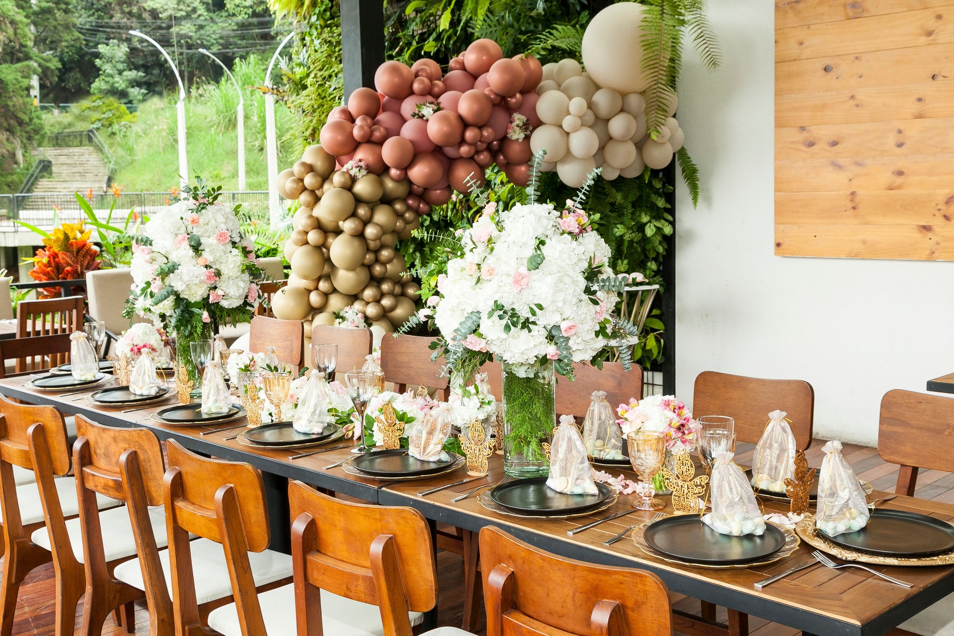 Decoration of party; A long table decorated with flowers for the reception of a social event.
